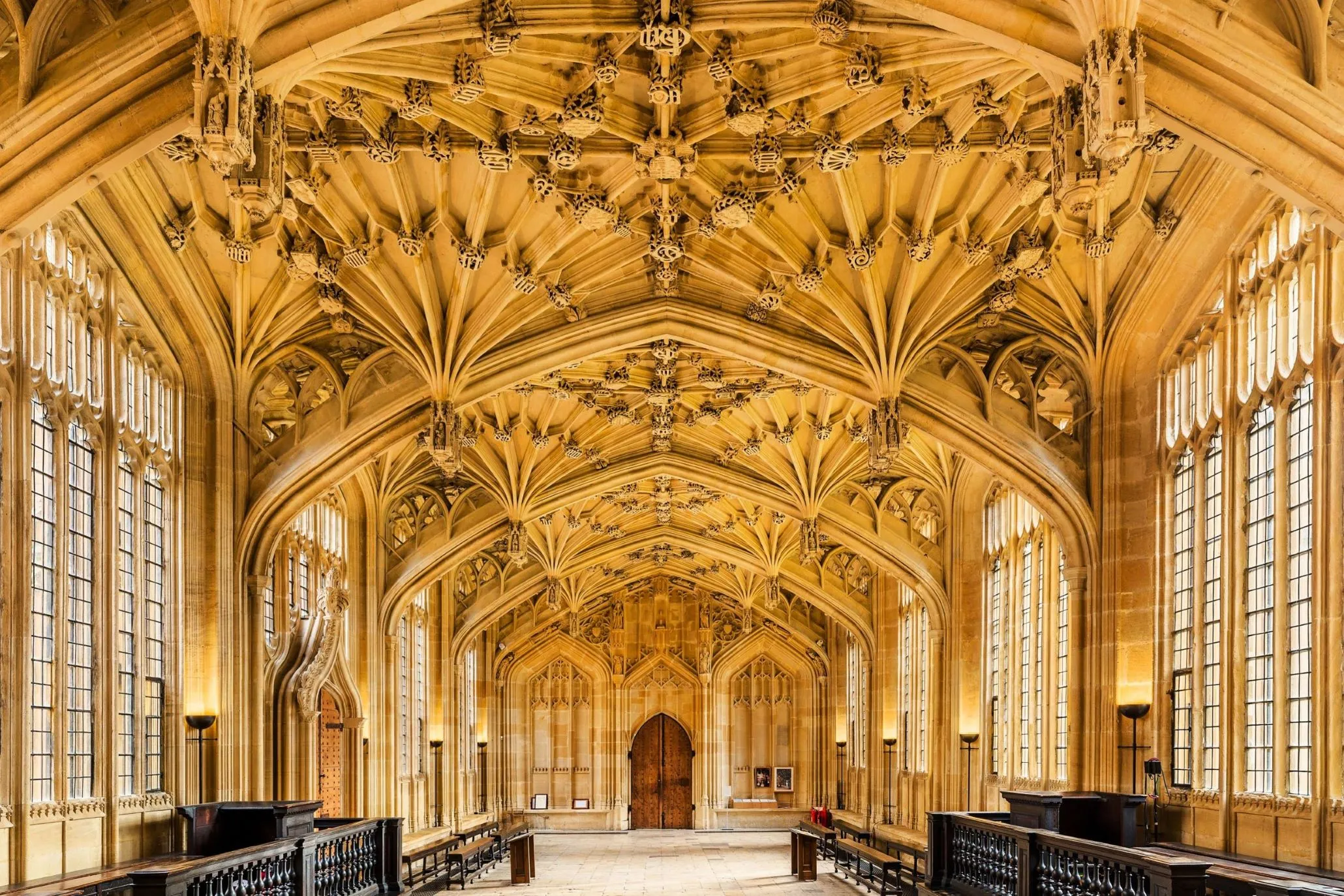 The inside of Divinity School, University of Oxford, displaying its intricate faux-fan vault ceiling.